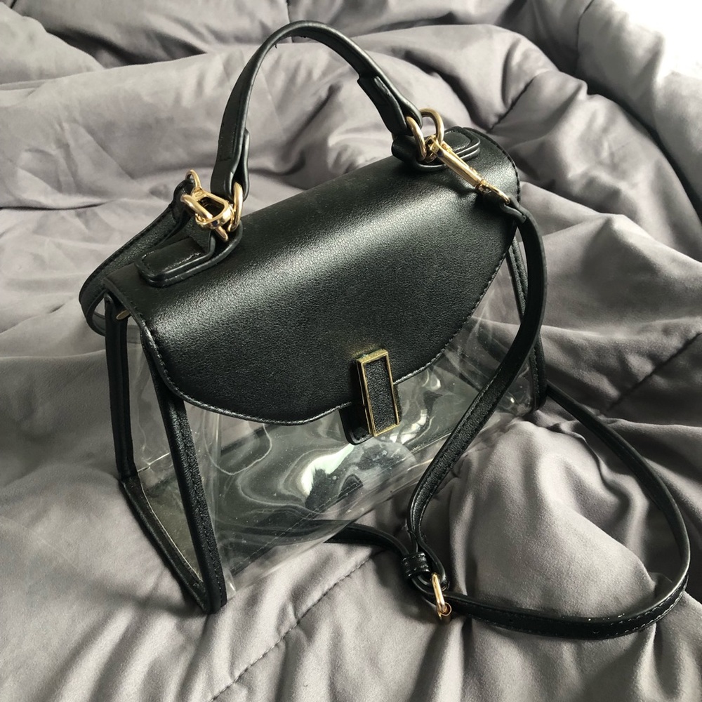 Clear handbag with black trim and gold hardware